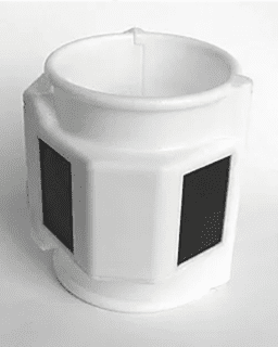 White cylindrical object with black panels.